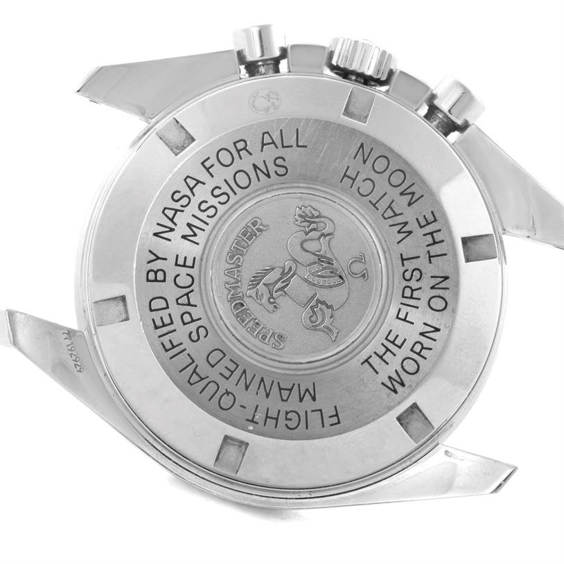 The image shows the case back and part of the crown of an Omega Speedmaster 3570.50.00 Men
s Stainless Steel Black Dial 3570.50.00 Men
s Stainless Steel Black Dial watch, highlighting its engraved text and logo.