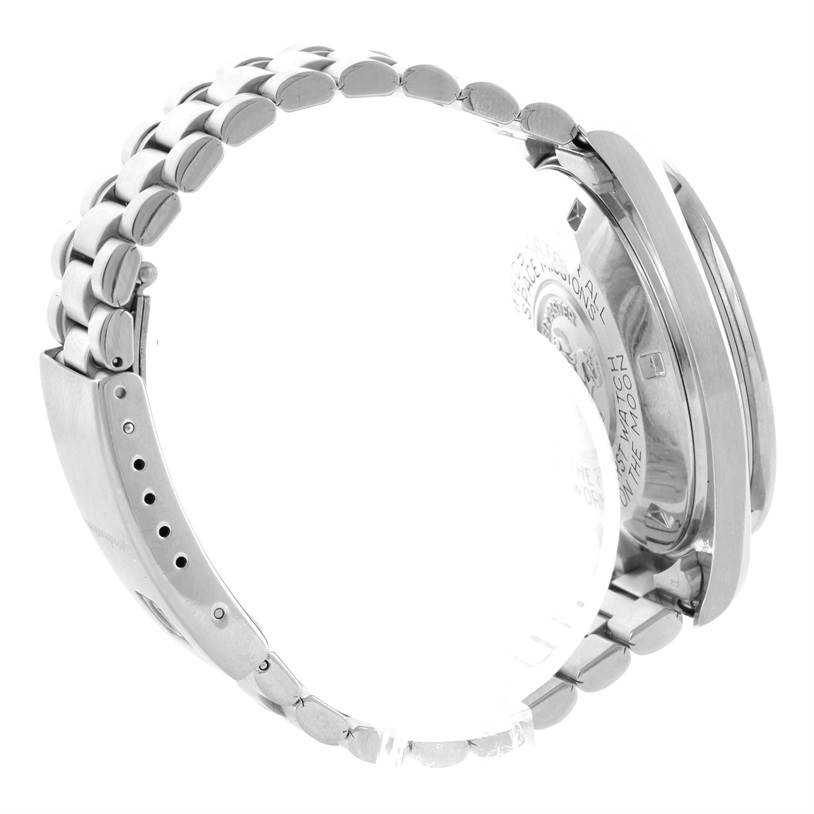 The image shows the side view of an Omega Speedmaster Men
s Stainless Steel Black Dial Men
s Stainless Steel Black Dial watch, focusing on the stainless steel bracelet and case back.