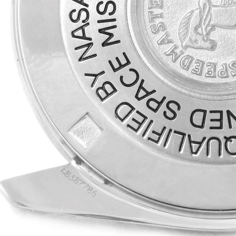 The image shows the engraved back case of an Omega Speedmaster 3570.50.00 Men
s Stainless Steel Black Dial 3570.50.00 Men
s Stainless Steel Black Dial watch from a side angle.