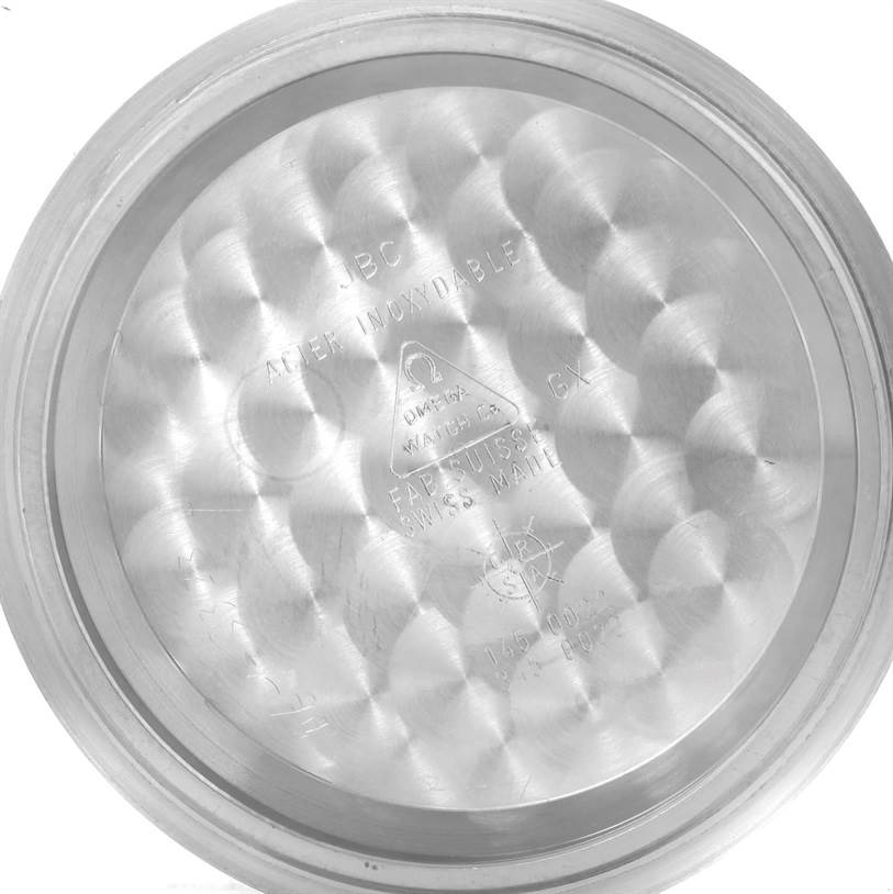 The image shows the inside case back of an Omega Speedmaster 3570.50.00 Men
s Stainless Steel Black Dial 3570.50.00 Men
s Stainless Steel Black Dial watch, featuring inscriptions and a brushed finish.