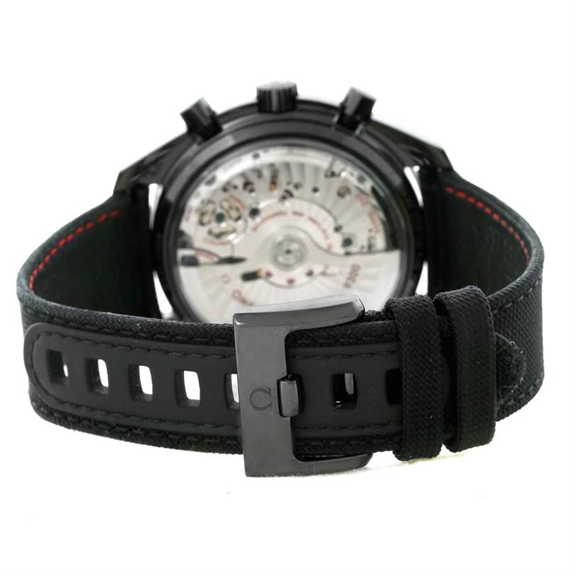 The image shows the back view of an Omega Speedmaster 311.92.44.51.01.003 Men's Stainless Steel Black Dial 311.92.44.51.01.003 Men's Stainless Steel Black Dial watch, focusing on the strap, buckle, and the watch's intricate movement.