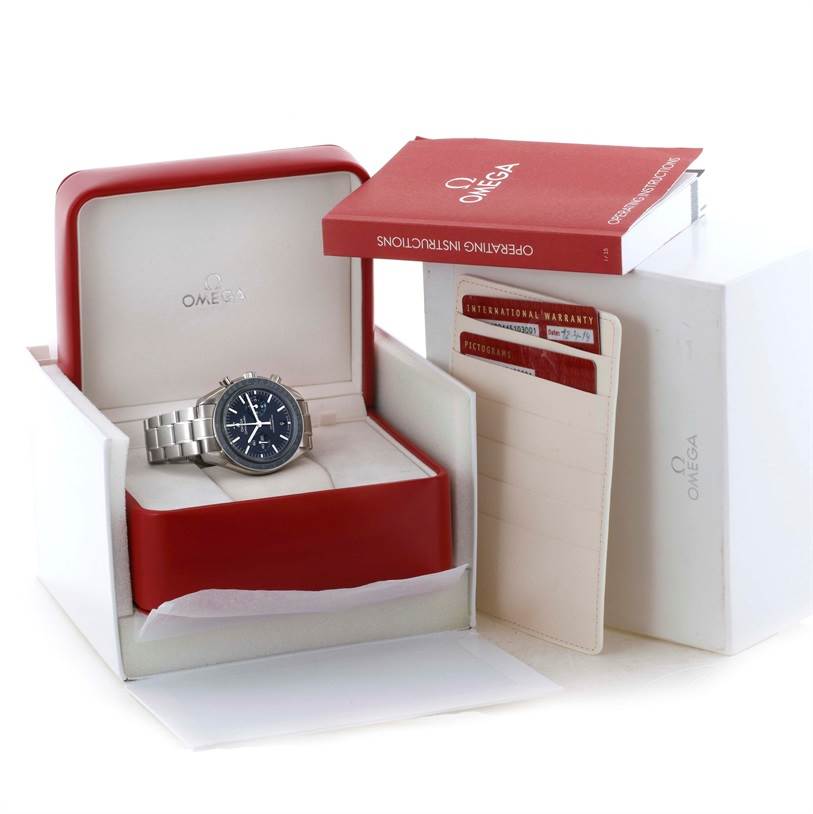 The Omega Speedmaster 311.90.44.51.03.001 Men
s Titanium Blue Dial 311.90.44.51.03.001 Men
s Titanium Blue Dial watch is displayed in its open box along with operating instructions and warranty cards.
