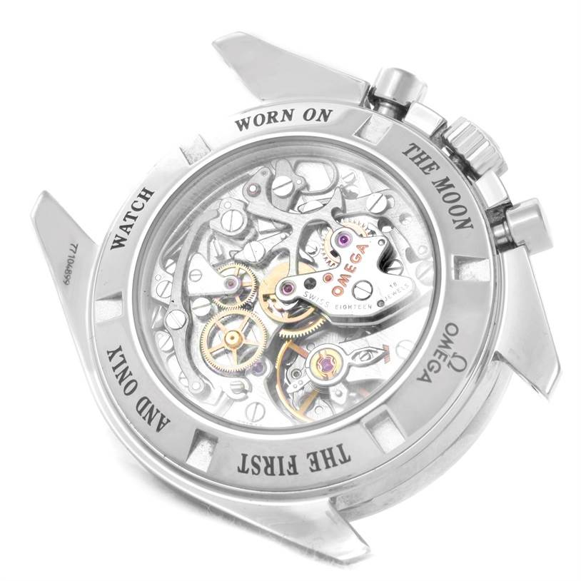 The image shows the back of the Omega Speedmaster 3573.50.00 Men
s Stainless Steel Black Dial 3573.50.00 Men
s Stainless Steel Black Dial watch, displaying its intricate movement and engravings on the case back.