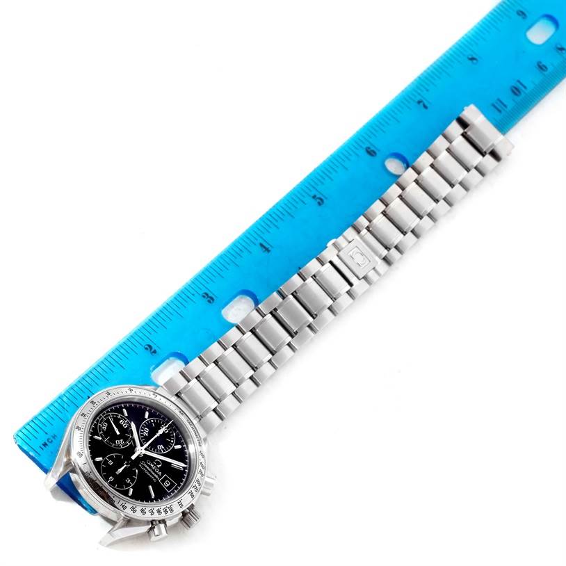 The image shows an Omega Speedmaster 3513.50.00 Men
s Stainless Steel Black Dial 3513.50.00 Men
s Stainless Steel Black Dial watch laid next to a blue ruler, displaying the face and full metal bracelet from an overhead angle.