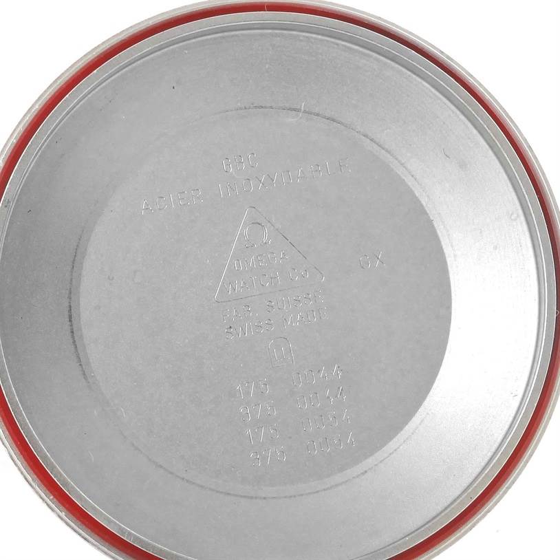 This image shows the inside of an Omega Speedmaster 3523.80.00 Men
s Stainless Steel Blue Dial 3523.80.00 Men
s Stainless Steel Blue Dial watch case back, featuring model and material engravings.