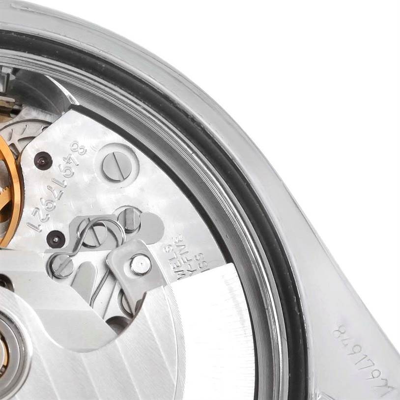 This image shows a close-up of the movement mechanism of an Omega Speedmaster 3220.50.00 Men
s Stainless Steel Black Dial 3220.50.00 Men
s Stainless Steel Black Dial watch, highlighting gears and components.