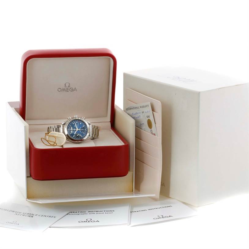 The Omega Speedmaster 3523.80.00 Men
s Stainless Steel Blue Dial 3523.80.00 Men
s Stainless Steel Blue Dial watch is displayed in its open box, accompanied by booklets and warranty cards.