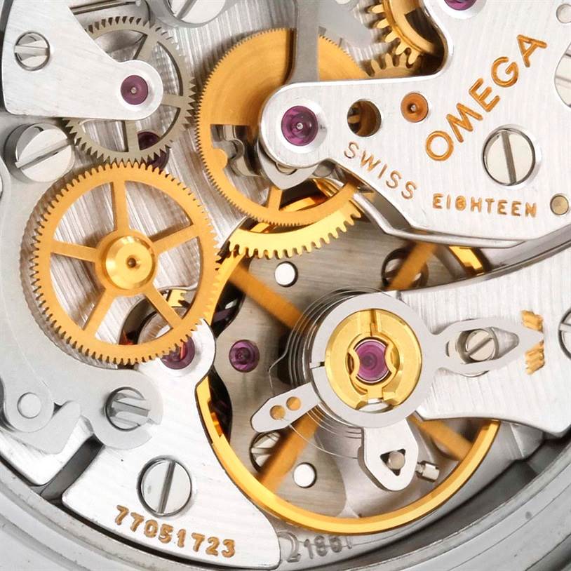 Close-up view of the Omega Speedmaster 3570.50.00 Men
s Stainless Steel Black Dial 3570.50.00 Men
s Stainless Steel Black Dial
s intricate inner mechanism, showcasing gears and the brand
s engraving.