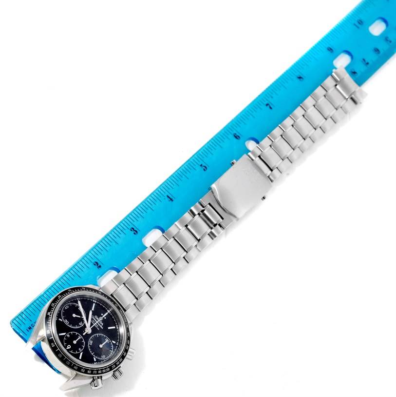 The image shows an Omega Speedmaster 326.30.40.50.01.001 Men
s Stainless Steel Black Dial 326.30.40.50.01.001 Men
s Stainless Steel Black Dial watch with a stainless steel band and clasp, measured with a blue ruler.