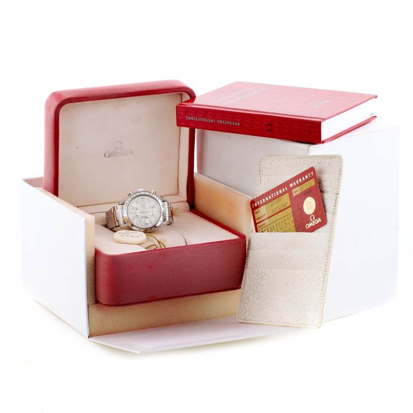 The Omega Speedmaster 3513.30.00 Men
s Stainless Steel Silver Dial 3513.30.00 Men
s Stainless Steel Silver Dial watch is displayed in an open box, accompanied by its warranty card and manual.