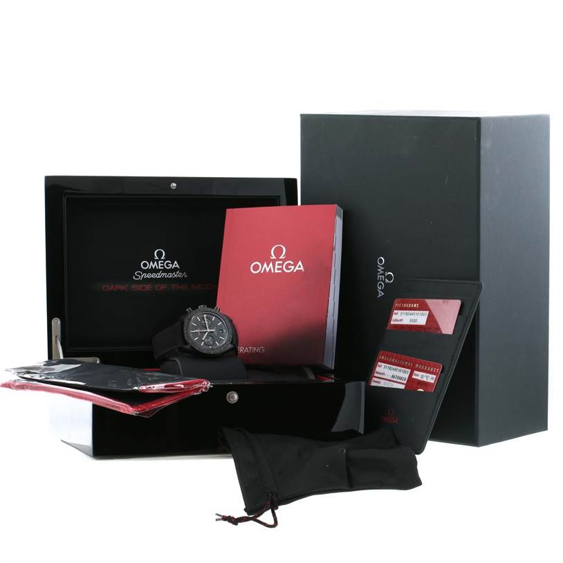 The image shows an Omega Speedmaster 311.92.44.51.01.003 Men
s Stainless Steel Black Dial 311.92.44.51.01.003 Men
s Stainless Steel Black Dial watch with its accessories, including manuals, cards, and packaging, all from a front angle.