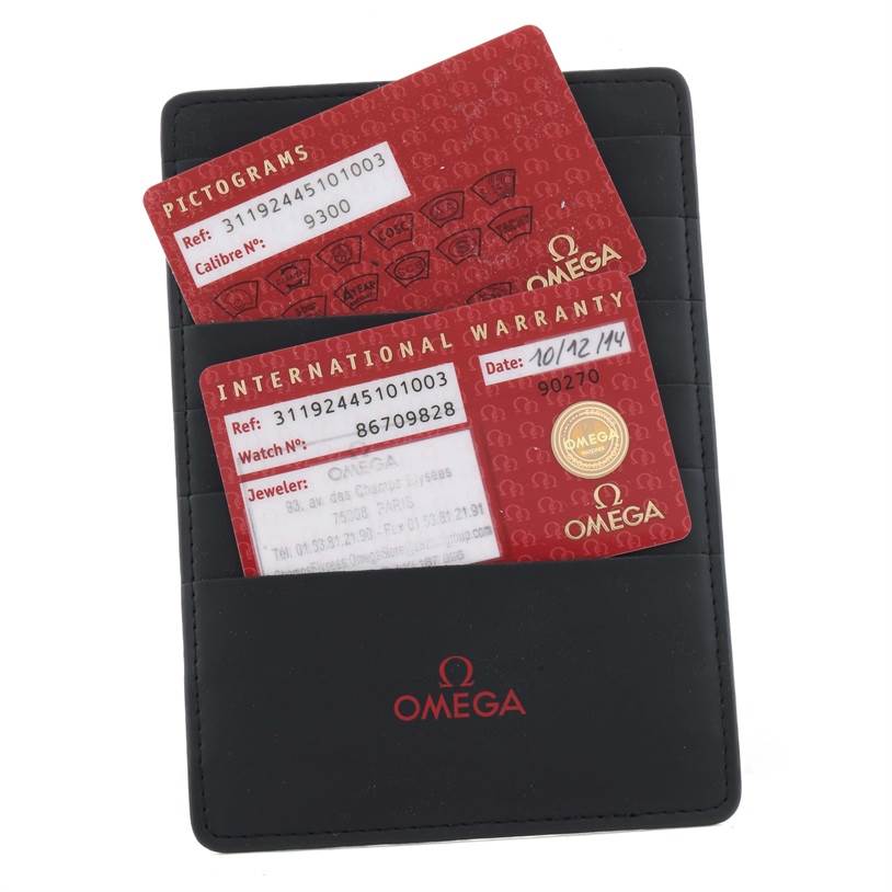 The image shows warranty cards for an Omega Speedmaster 311.92.44.51.01.003 Men
s Stainless Steel Black Dial 311.92.44.51.01.003 Men
s Stainless Steel Black Dial watch placed inside a black Omega cardholder.