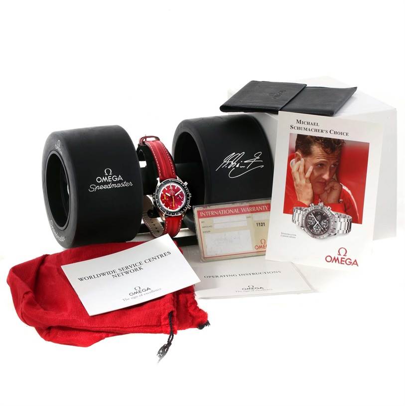 The image shows an Omega Speedmaster 3510.61.00 Men's Stainless Steel Red Dial 3510.61.00 Men's Stainless Steel Red Dial watch with packaging, warranty card, instruction manual, and case accessories.