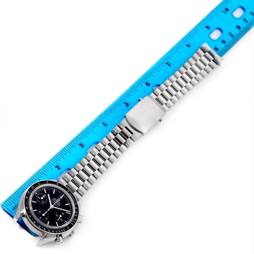 The image shows an Omega Speedmaster 3539.50.00 Men
s Stainless Steel Black Dial 3539.50.00 Men
s Stainless Steel Black Dial watch laid flat next to a blue ruler, highlighting its face and metallic bracelet.