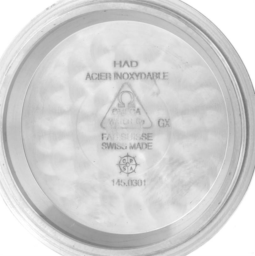 The image shows the inner case back of an Omega Speedmaster 311.30.42.30.01.001 Men's Stainless Steel Black Dial 311.30.42.30.01.001 Men's Stainless Steel Black Dial watch displaying its engravings and marks.