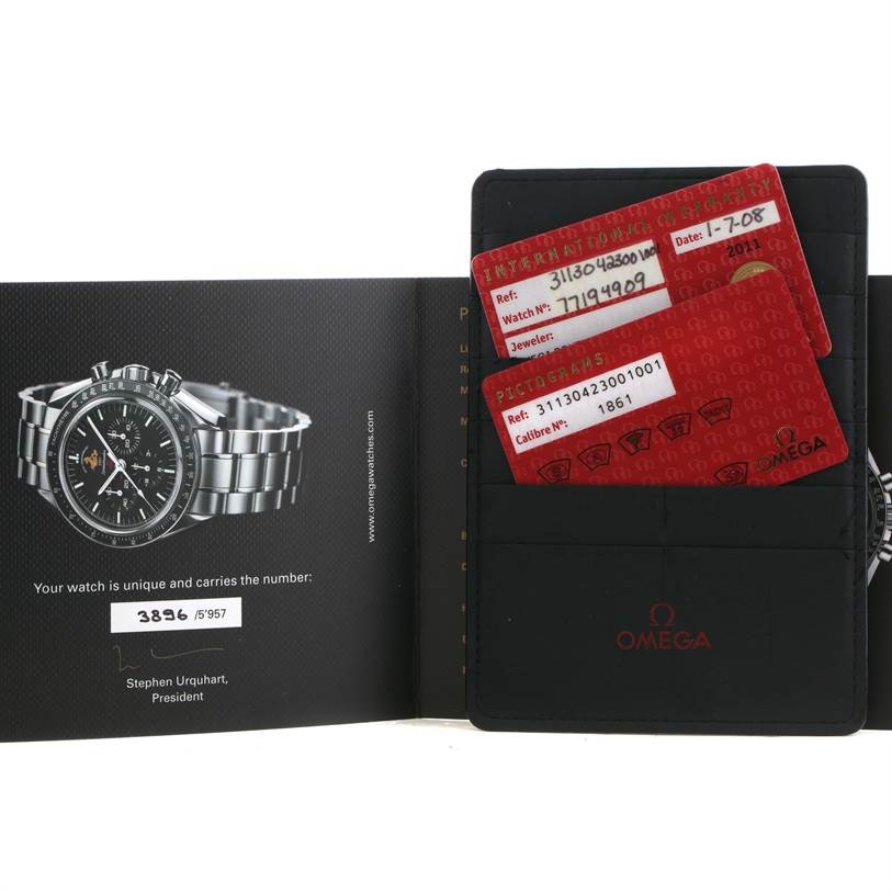 The image shows an Omega Speedmaster 311.30.42.30.01.001 Men's Stainless Steel Black Dial 311.30.42.30.01.001 Men's Stainless Steel Black Dial watch alongside its warranty card and pictogram cards in a wallet.