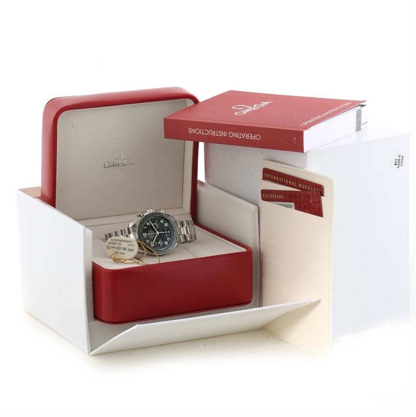 The Omega Speedmaster 324.30.38.40.06.001 Men
s Stainless Steel Grey Dial 324.30.38.40.06.001 Men
s Stainless Steel Grey Dial watch is shown in its open red box, accompanied by a warranty card and instruction booklet.