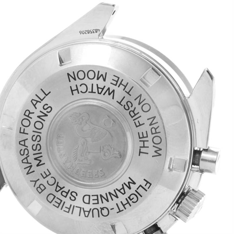 The image shows the back view of an Omega Speedmaster Men
s Stainless Steel Black Dial Men
s Stainless Steel Black Dial, highlighting the engraved case back and crown.