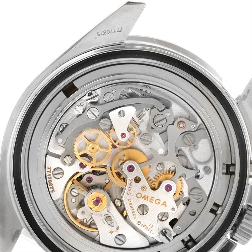 The image shows a close-up of the Omega Speedmaster 3570.50.00 Men
s Stainless Steel Black Dial 3570.50.00 Men
s Stainless Steel Black Dial
s movement, showcasing its intricate internal mechanical components.