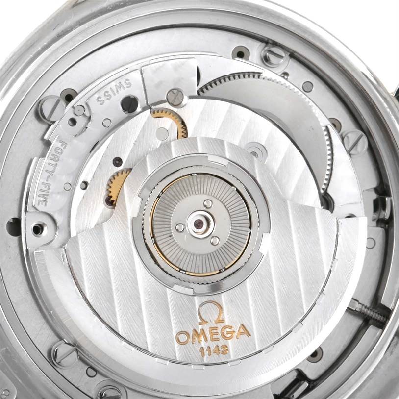This is a close-up view of the internal movement of an Omega Speedmaster 3310.10 Men's Steel and Gold (two tone) Champagne Dial 3310.10 Men's Steel and Gold (two tone) Champagne Dial watch, showcasing the gears and the Omega logo.