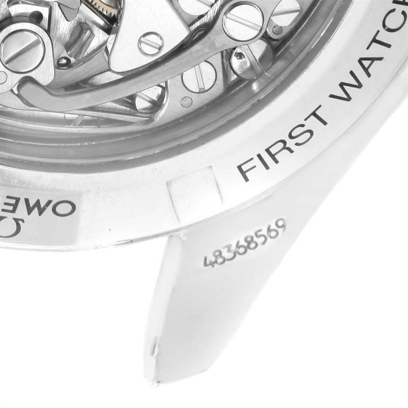 The image shows a close-up of the Omega Speedmaster 3572.50.00 Men's Stainless Steel Black Dial 3572.50.00 Men's Stainless Steel Black Dial's back case, exposing the inner mechanical components and partial text.