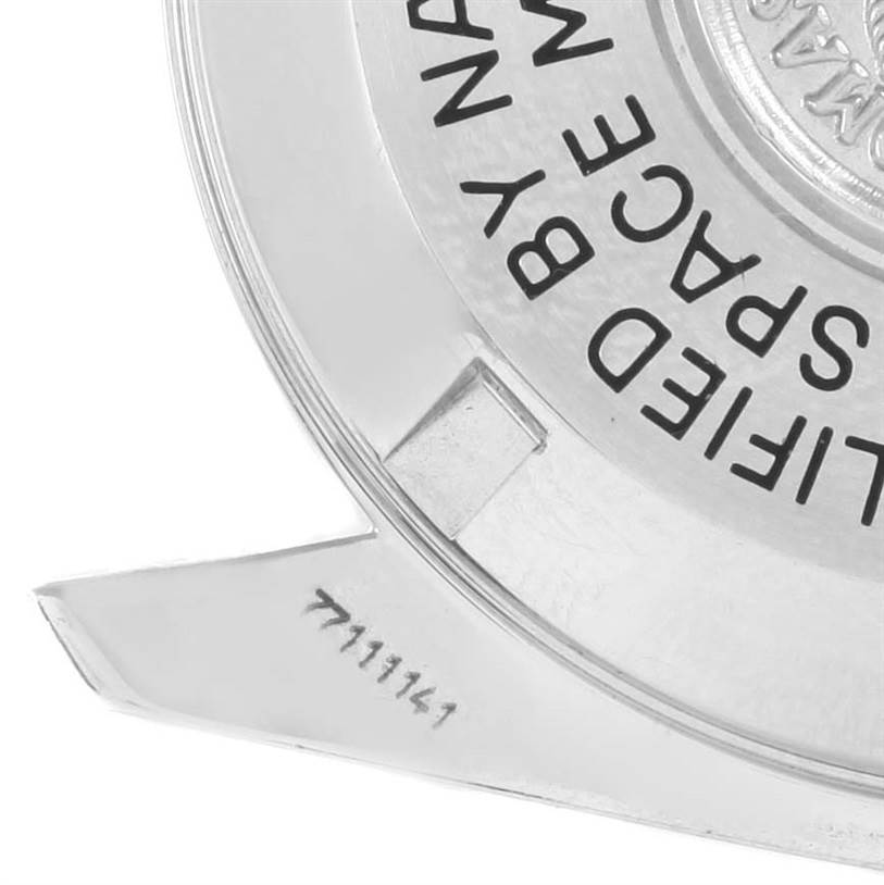 This image shows a zoomed-in view of the case back of an Omega Speedmaster 3570.50.00 Men
s Stainless Steel Black Dial 3570.50.00 Men
s Stainless Steel Black Dial watch, including some text and a partial serial number.