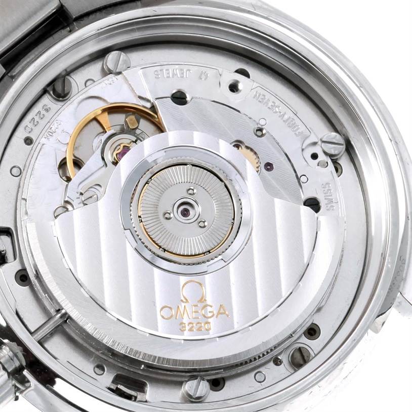 The image shows a close-up of the movement mechanism of an Omega Speedmaster 3539.50.00 Men
s Stainless Steel Black Dial 3539.50.00 Men
s Stainless Steel Black Dial, highlighting its intricate details and branding.