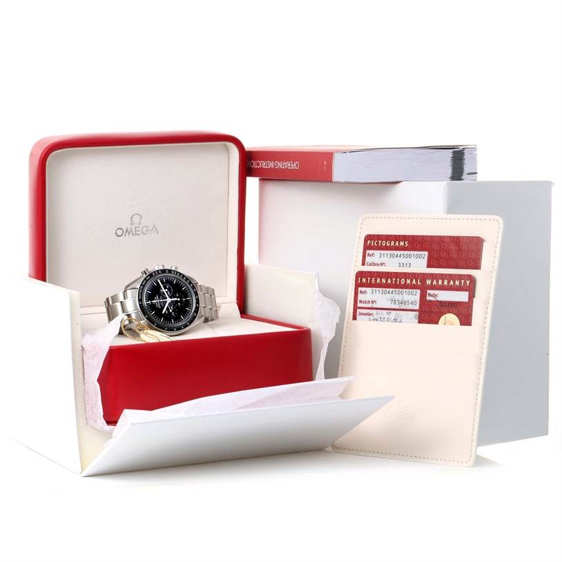 The Omega Speedmaster 311.30.44.50.01.002 Men
s Stainless Steel Black Dial 311.30.44.50.01.002 Men
s Stainless Steel Black Dial watch is displayed at a resting angle with its accessories, including an international warranty card, in its original packaging.