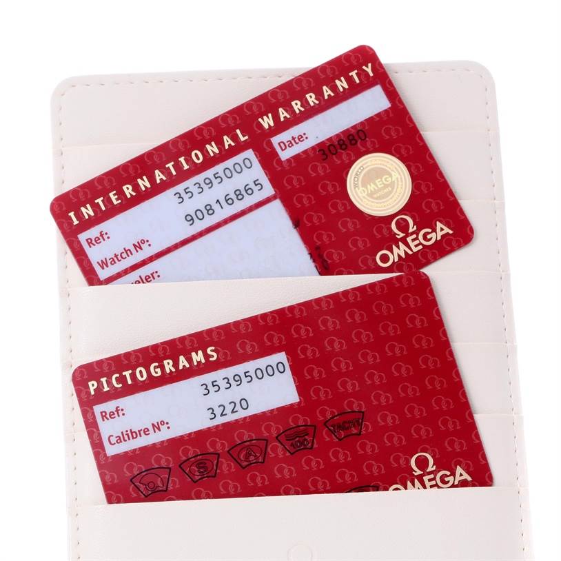 The image shows the International Warranty and Pictograms cards for an Omega Speedmaster 3539.50.00 Men
s Stainless Steel Black Dial 3539.50.00 Men
s Stainless Steel Black Dial watch, partially inside a white cardholder.