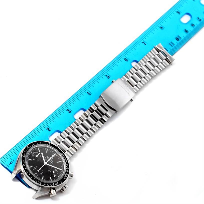 The image shows an Omega Speedmaster 3539.50.00 Men
s Stainless Steel Black Dial 3539.50.00 Men
s Stainless Steel Black Dial watch laid flat with its bracelet and clasp visible, next to a ruler for scale.