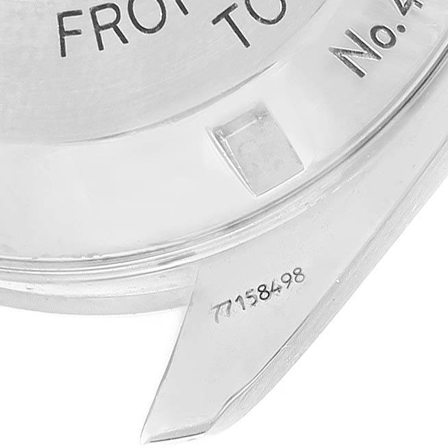 This image shows a close-up of the case back and the lugs of an Omega Speedmaster 3577.50.00 Men's Stainless Steel Black Dial 3577.50.00 Men's Stainless Steel Black Dial watch, featuring engravings.