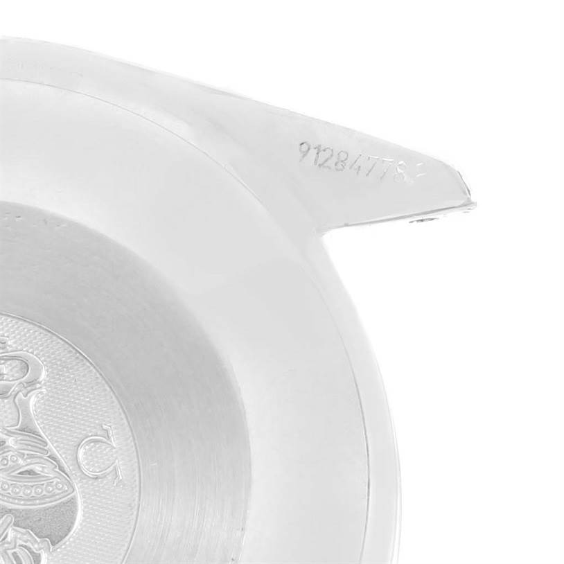 The image shows the back casing with an emblem and serial number of an Omega Speedmaster 3539.50.00 Men
s Stainless Steel Black Dial 3539.50.00 Men
s Stainless Steel Black Dial watch, viewed from the side.