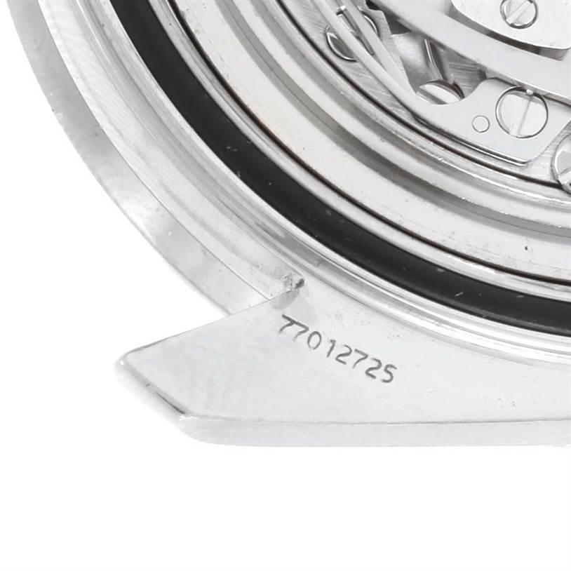 The image shows a close-up view of the Omega Speedmaster 3560.50.00 Men
s Stainless Steel Black Dial 3560.50.00 Men
s Stainless Steel Black Dial
s case back and part of its movement.