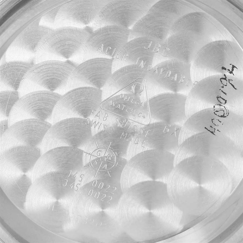 The image shows the interior of the case back for an Omega Speedmaster 3570.50.00 Men
s Stainless Steel Black Dial 3570.50.00 Men
s Stainless Steel Black Dial watch, engraved with various markings and text.