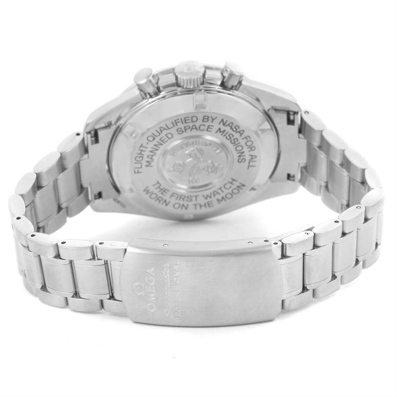 The image shows the back case and bracelet of an Omega Speedmaster 3570.50.00 Men
s Stainless Steel Black Dial 3570.50.00 Men
s Stainless Steel Black Dial model watch, highlighting the engraved text on the case back.