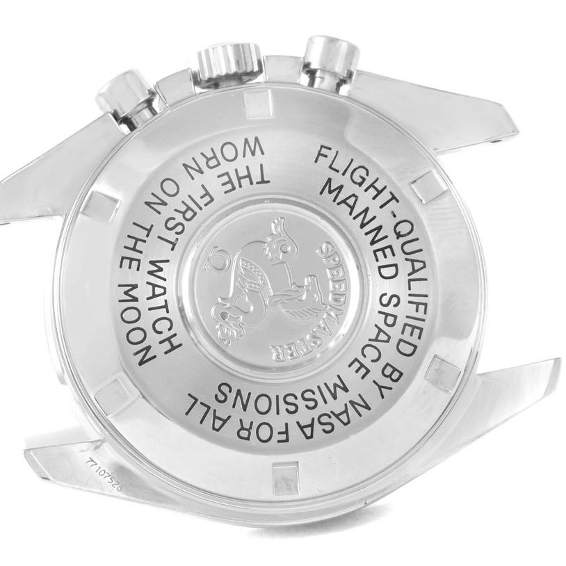 The image shows the back case of an Omega Speedmaster 3570.50.00 Men
s Stainless Steel Black Dial 3570.50.00 Men
s Stainless Steel Black Dial watch, highlighting its engravings and crown side.