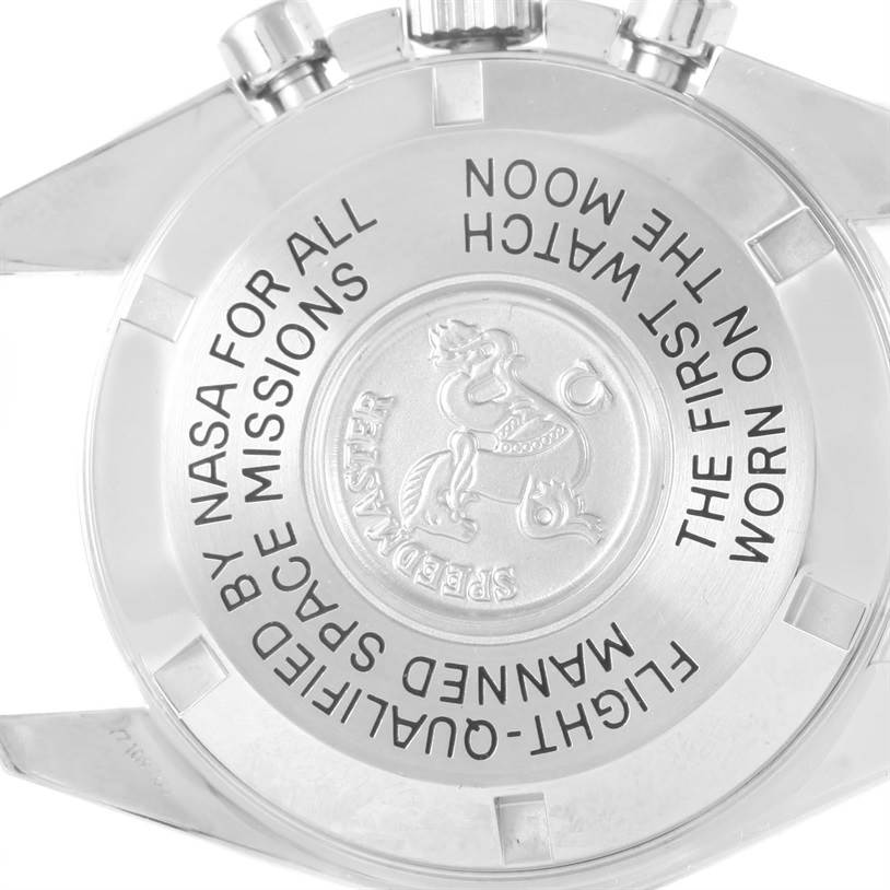 The image shows the case back of an Omega Speedmaster 3570.50.00 Men
s Stainless Steel Black Dial 3570.50.00 Men
s Stainless Steel Black Dial watch, displaying engraved text and a medallion.