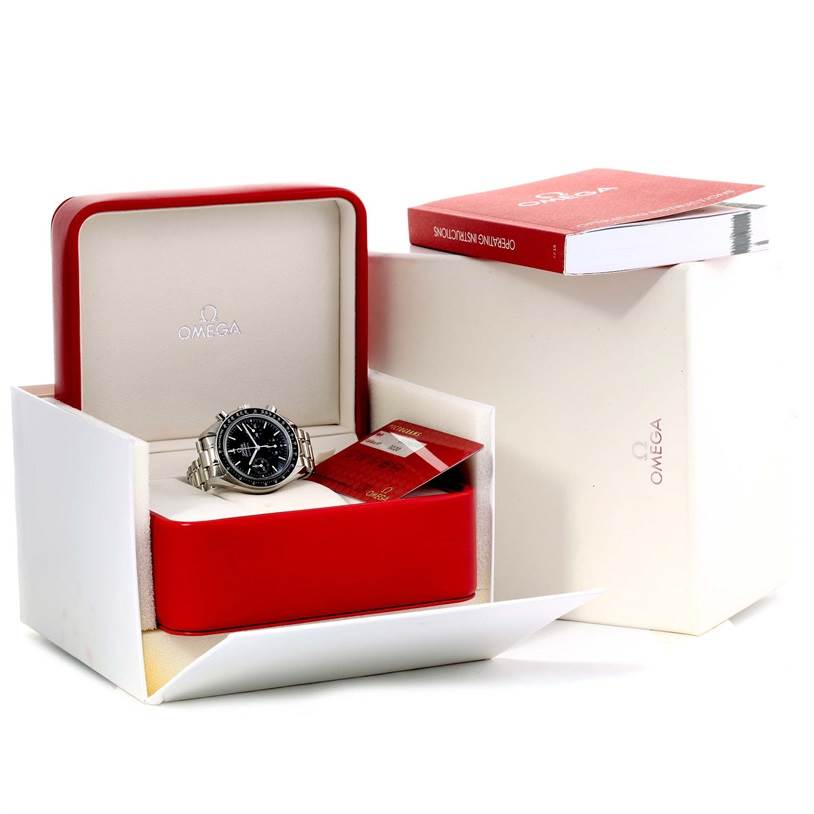 The image shows an Omega Speedmaster 3539.50.00 Men
s Stainless Steel Black Dial 3539.50.00 Men
s Stainless Steel Black Dial watch in its open case with a manual and warranty card adjacent to it.