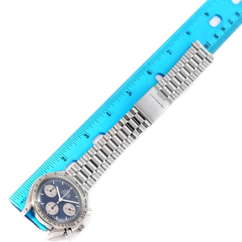 The Omega Speedmaster 3510.82.00 Men
s Stainless Steel Blue Dial 3510.82.00 Men
s Stainless Steel Blue Dial watch is shown from the top, displaying its face, strap, and a ruler for scale.