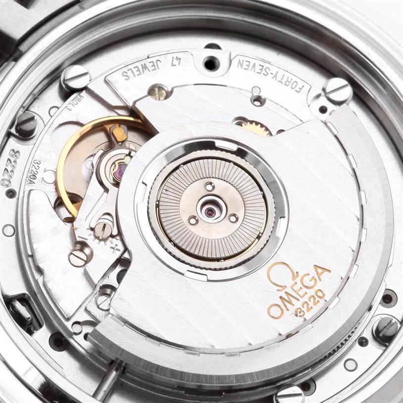 The image shows a close-up view of the movement mechanism inside an Omega Speedmaster 3539.50.00 Men
s Stainless Steel Black Dial 3539.50.00 Men
s Stainless Steel Black Dial watch, highlighting intricate parts and engravings.