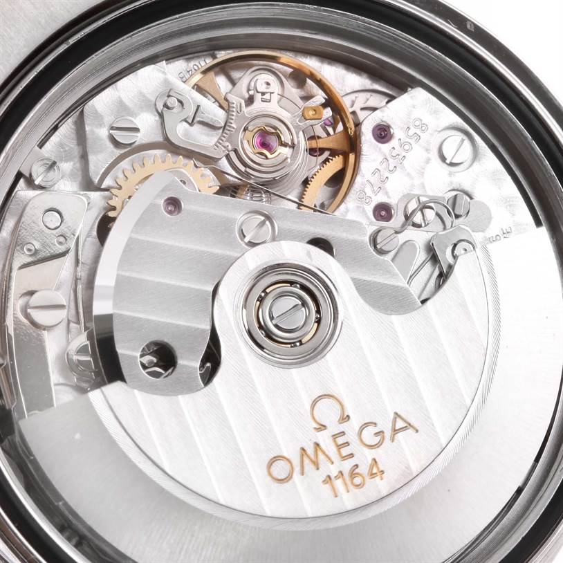 The image shows a close-up view of the Omega Speedmaster 3212.80.00 Men
s Stainless Steel Blue Dial 3212.80.00 Men
s Stainless Steel Blue Dial
s movement, showcasing the intricate inner workings and the Omega 1164 markings.
