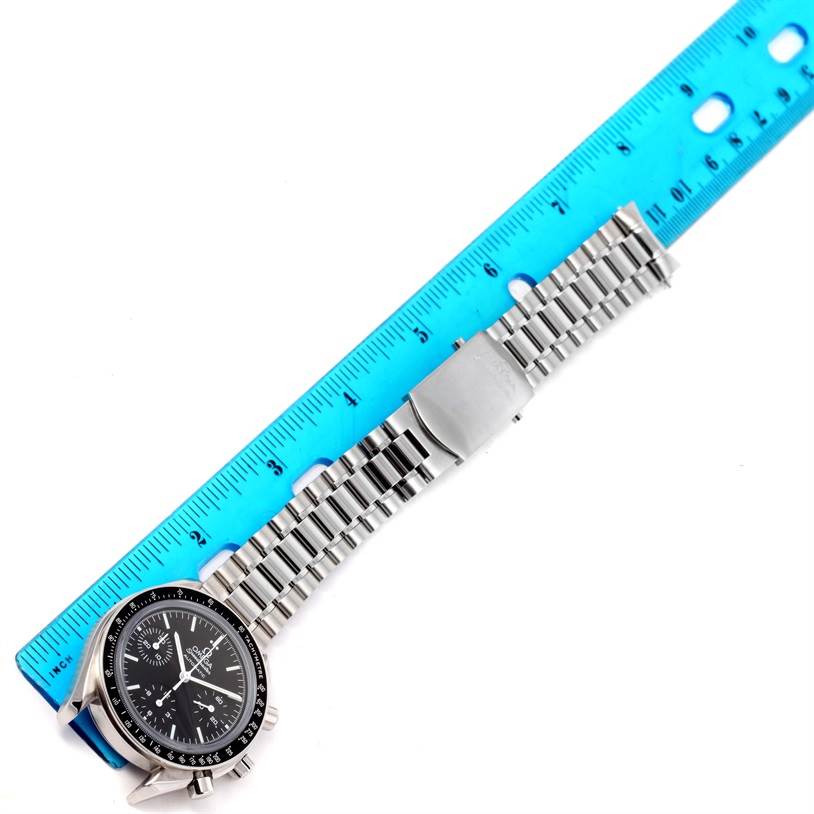 The Omega Speedmaster 3539.50.00 Men's Stainless Steel Black Dial 3539.50.00 Men's Stainless Steel Black Dial watch is shown at an angle from above, displaying its face, bezel, and metal bracelet next to a ruler.