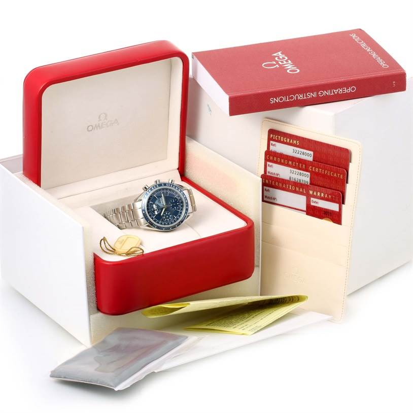 The Omega Speedmaster 3222.80.00 Men
s Stainless Steel Blue Dial 3222.80.00 Men
s Stainless Steel Blue Dial watch is shown in an open box with instruction manuals and warranty cards on display.