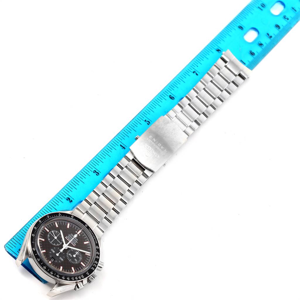 The image shows an Omega Speedmaster 3552.59.00 Men
s Stainless Steel Black Dial 3552.59.00 Men
s Stainless Steel Black Dial watch with its bracelet measured against a blue ruler, highlighting the face and band.