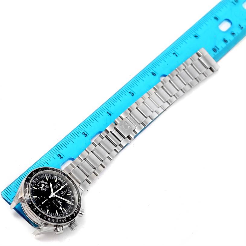 This image shows the Omega Speedmaster 3520.50.00 Men
s Stainless Steel Black Dial 3520.50.00 Men
s Stainless Steel Black Dial watch laid flat with the face and full metal bracelet visible next to a blue ruler.