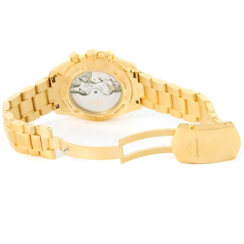 The image shows the back and clasp of an Omega Speedmaster 321.50.42.50.02.001 Men's Yellow Gold Silver Dial 321.50.42.50.02.001 Men's Yellow Gold Silver Dial watch with a gold bracelet and transparent case back.