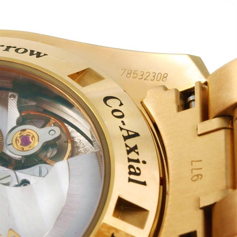 This is a close-up of the back of an Omega Speedmaster 321.50.42.50.02.001 Men's Yellow Gold Silver Dial 321.50.42.50.02.001 Men's Yellow Gold Silver Dial watch, displaying part of the movement through a transparent case back.