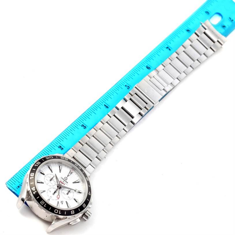 The image shows an Omega Speedmaster 231.10.44.52.04.001 Men
s Stainless Steel White Dial 231.10.44.52.04.001 Men
s Stainless Steel White Dial watch laid flat, focusing on its face, bezel, and metal bracelet next to a blue ruler.