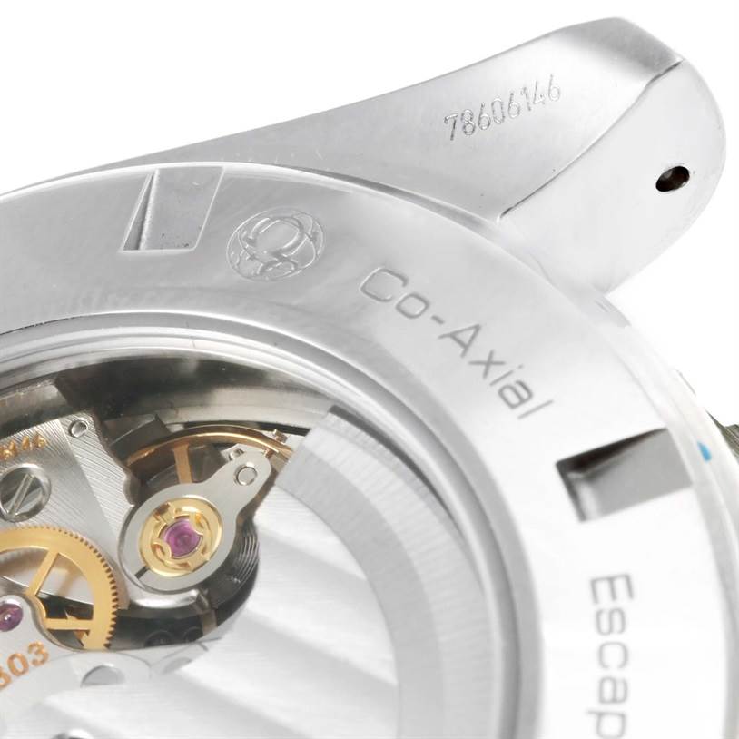 This image shows a close-up of the Omega Speedmaster 231.10.44.52.04.001 Men
s Stainless Steel White Dial 231.10.44.52.04.001 Men
s Stainless Steel White Dial
s Co-Axial escapement and part of the case back with visible serial number.