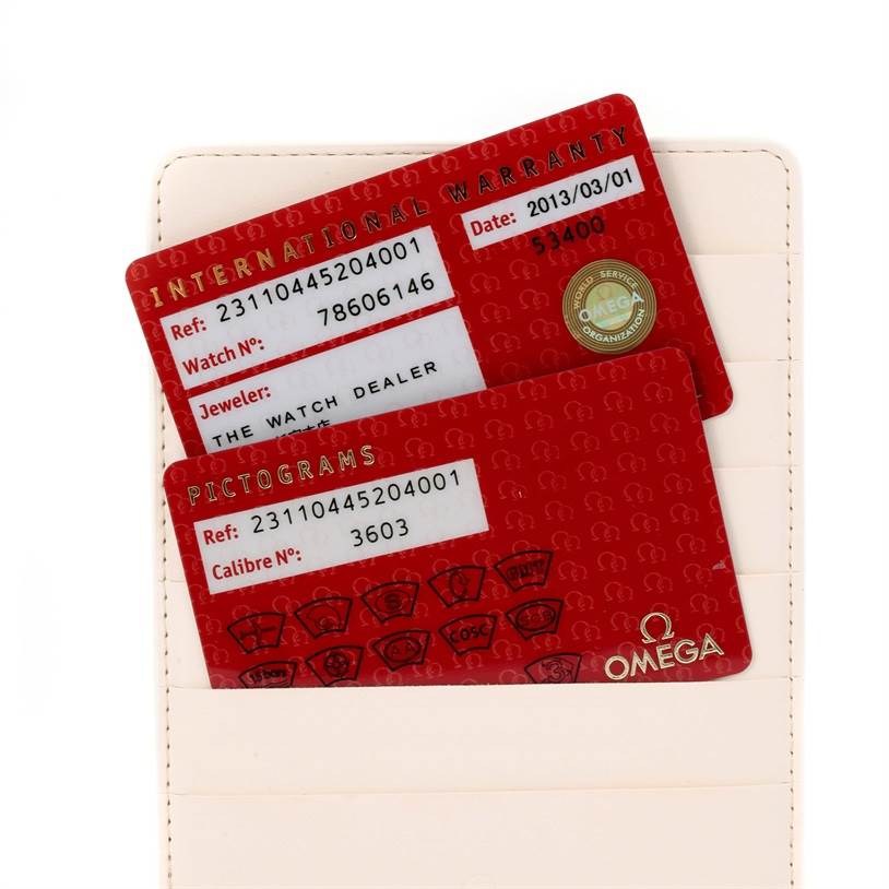 Shown are two warranty and pictogram cards for an Omega Speedmaster 231.10.44.52.04.001 Men
s Stainless Steel White Dial 231.10.44.52.04.001 Men
s Stainless Steel White Dial watch, partially inside a card holder.